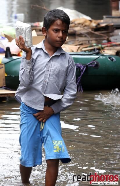 Little boy collecting flood rations, Sri Lanka (2) - Read Photos