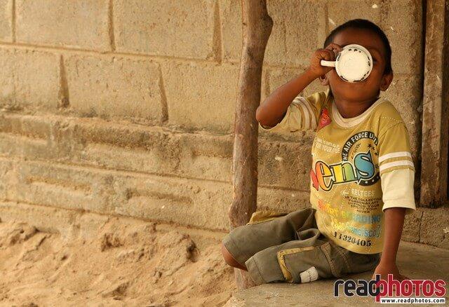 A young boy drinking water, Sri Lanka - Read Photos