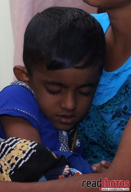 Little boy sleep on mothers hands, Sri Lanka